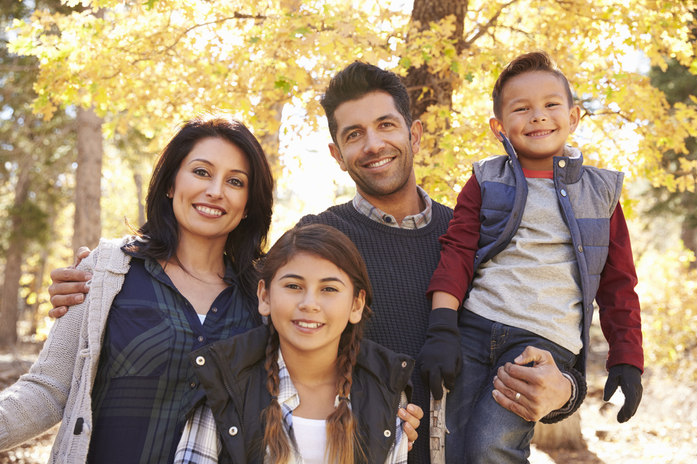 Parents and two children smiling down at camera