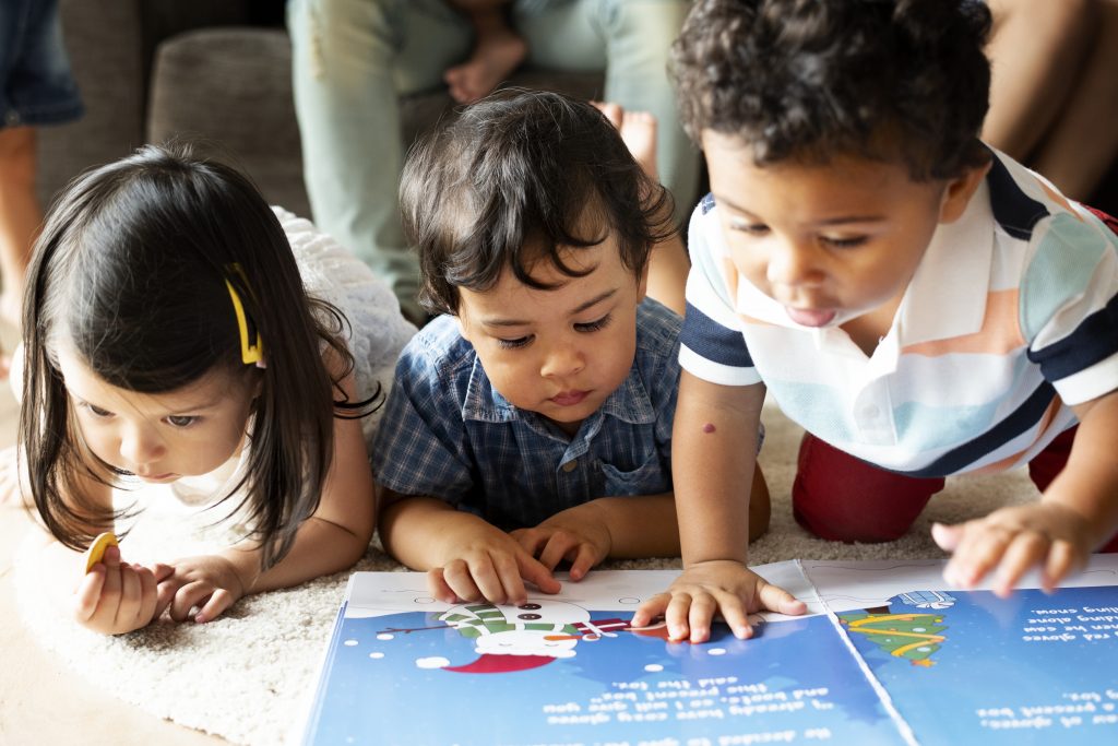 group of toddlers looking at a map together