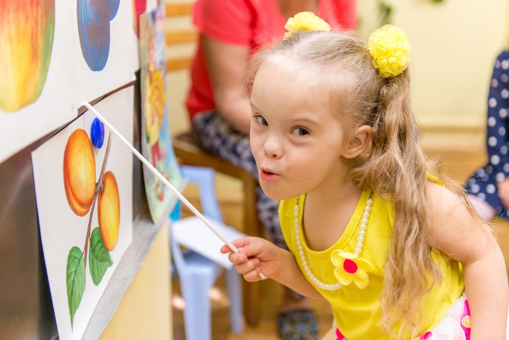 Girl with down syndrome painting