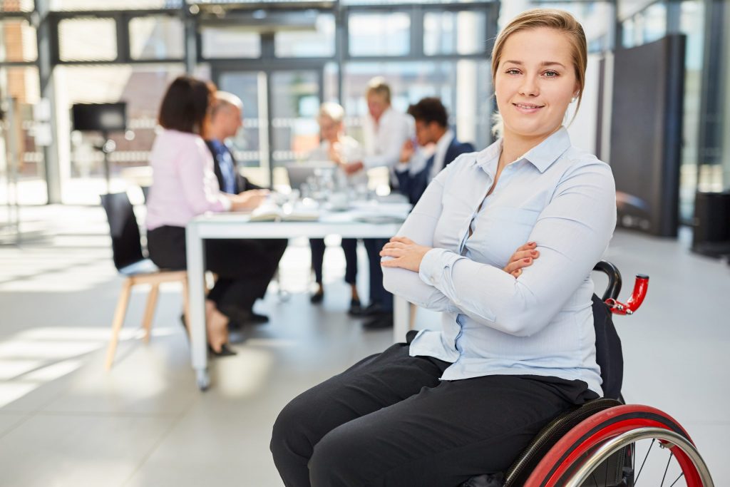 Proud disabled woman in a wheelchair at a meeting transition to adulthood