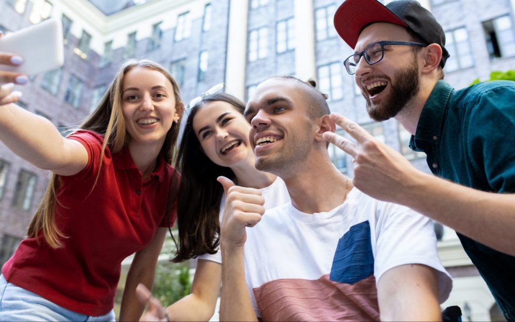 Group of friends taking a selfie. Transition to adulthood for individuals with disabilities.