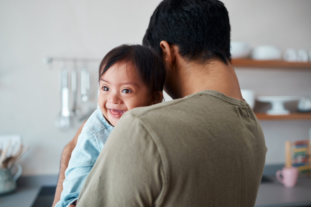 Father holding his baby who has Down syndrome