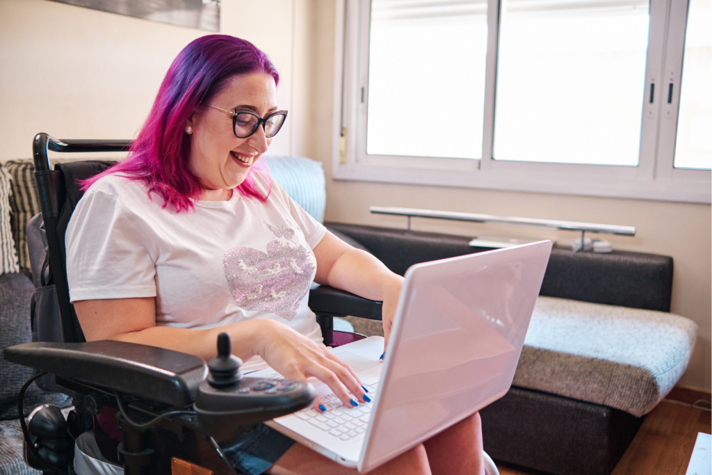 Woman in a wheelchair using her laptop